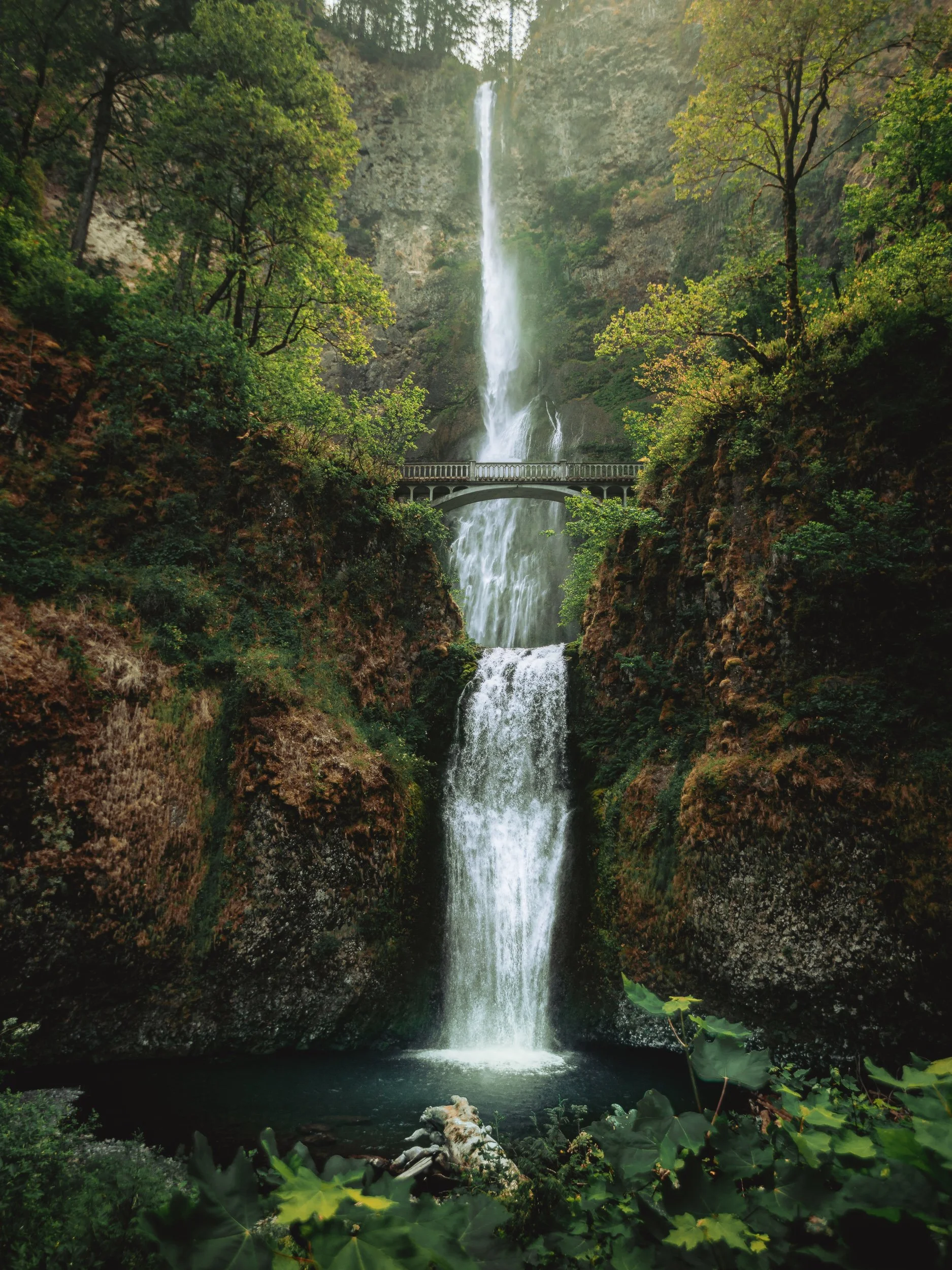 Multnomah Falls cascading past the stone bridge in the Columbia River Gorge Oregon, waterfall landscape photography by James Brasier