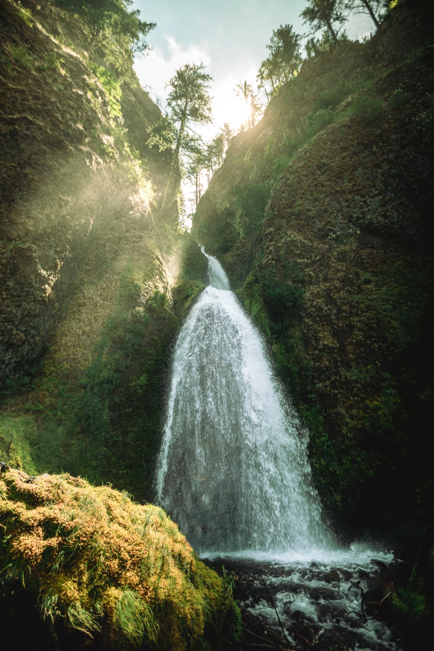 Wahkeena Falls with sunlight beams streaming through a mossy canyon in the Columbia River Gorge Oregon, waterfall photography by James Brasier