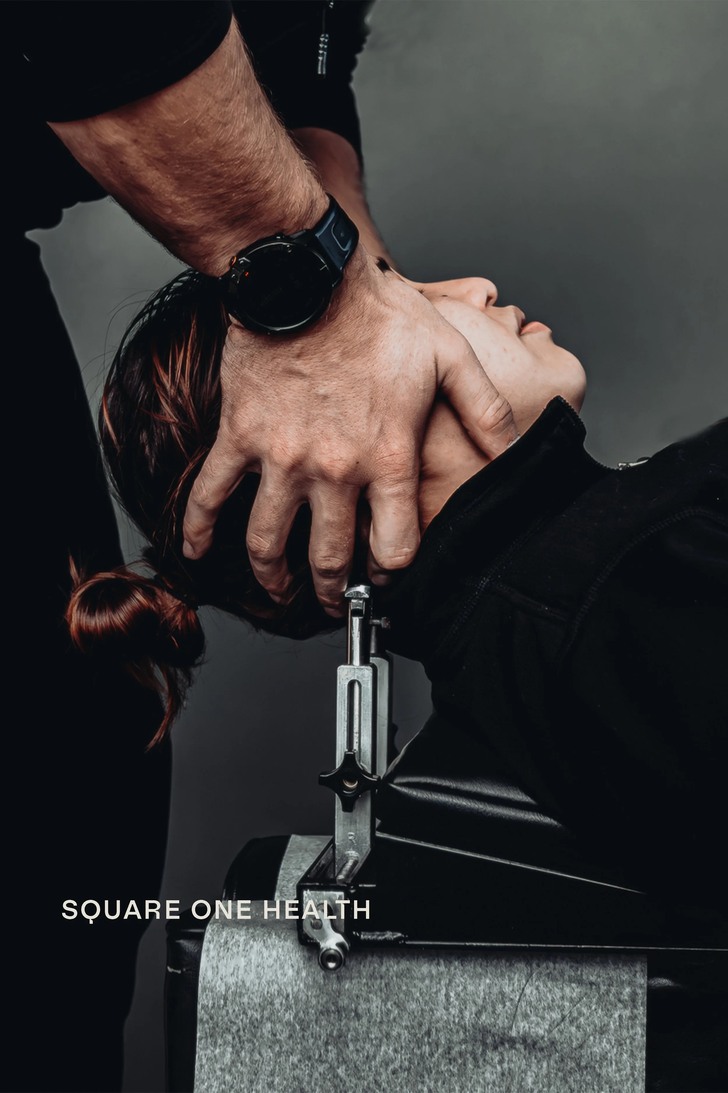 Chiropractor performing cervical adjustment at Square One Health, commercial photography by James Brasier