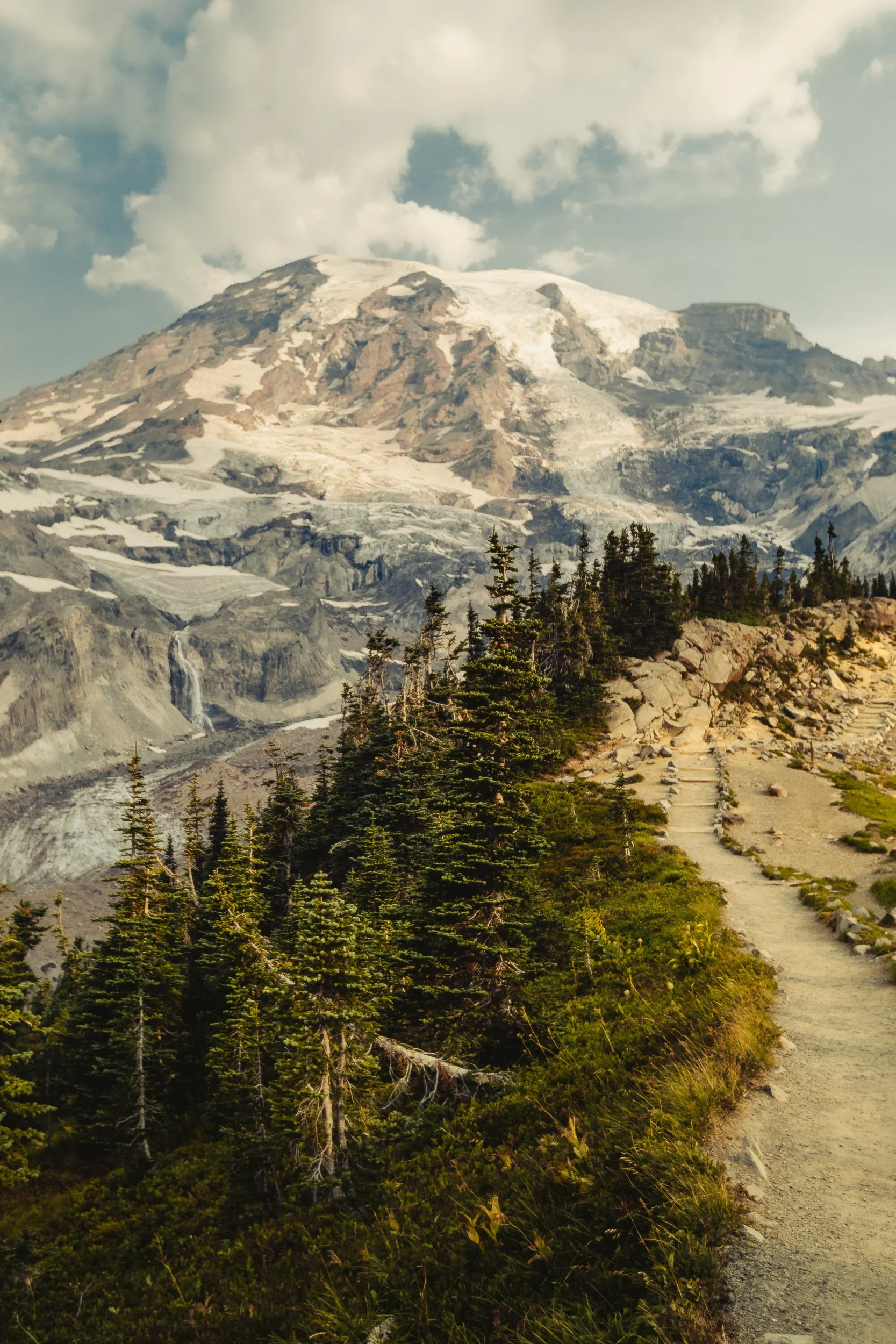 Hiking trail leading toward Mount Rainier with glaciers and evergreen trees in the Cascade Range, Washington landscape photography by James Brasier