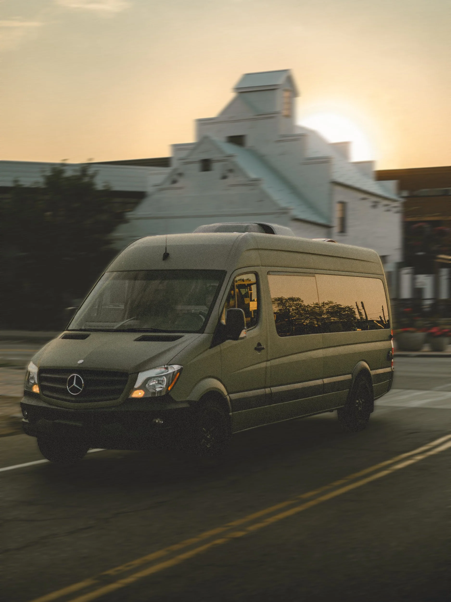 Nomad Mobile Barbershop van in motion at golden hour with background blur on a Northern Colorado street, brand lifestyle photography by James Brasier