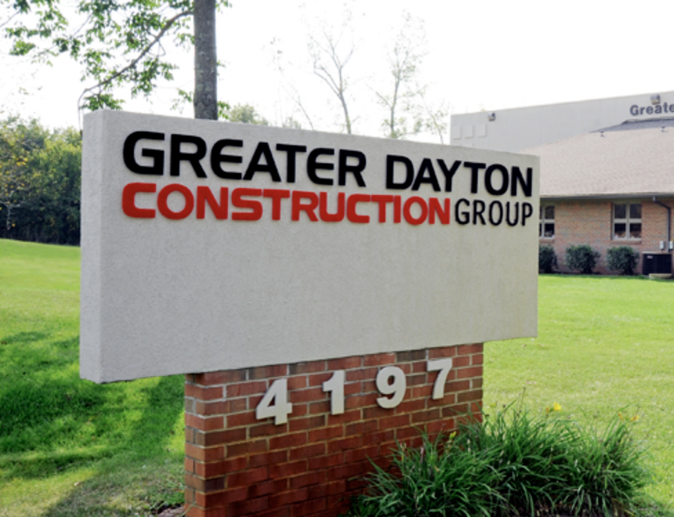 Sign for Greater Dayton Construction Group with address 4197 on brick base, outside building on green lawn