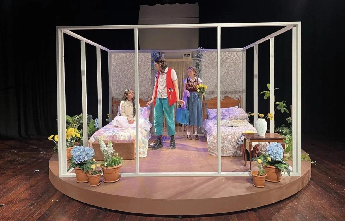 Stage set of a bedroom with 4 open walls on a circular platform.