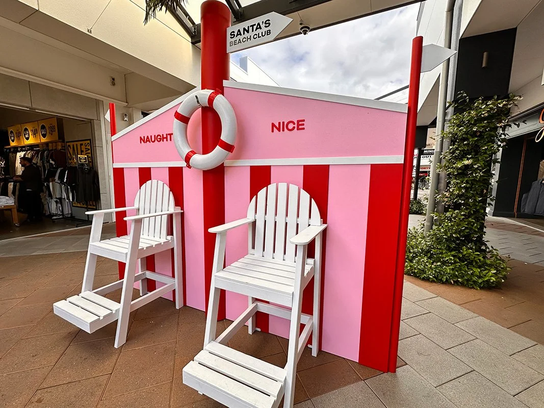 An image of a red and pink santa's beach club in a mall.