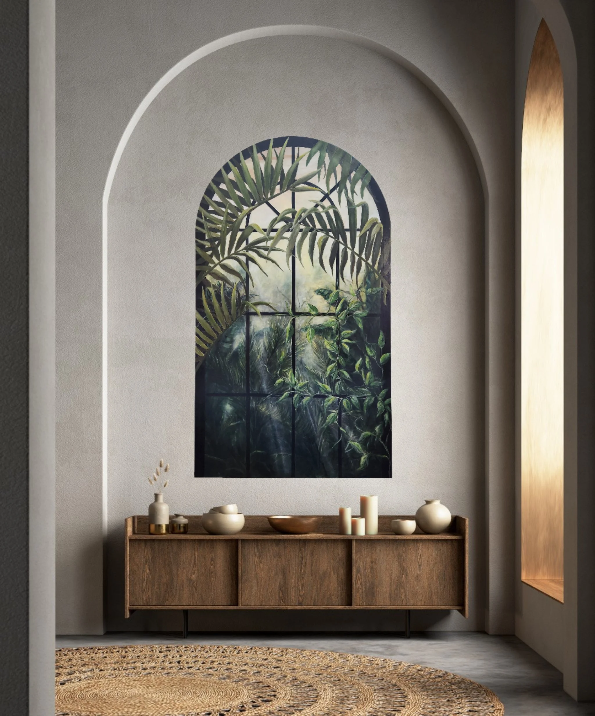 A minimalist interior with a wooden console table, decorative vases, and candles, in front of a large arched window with tropical jungle scenery depicted through stained glass.