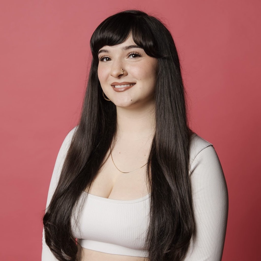 Woman with dark hair in black turtleneck