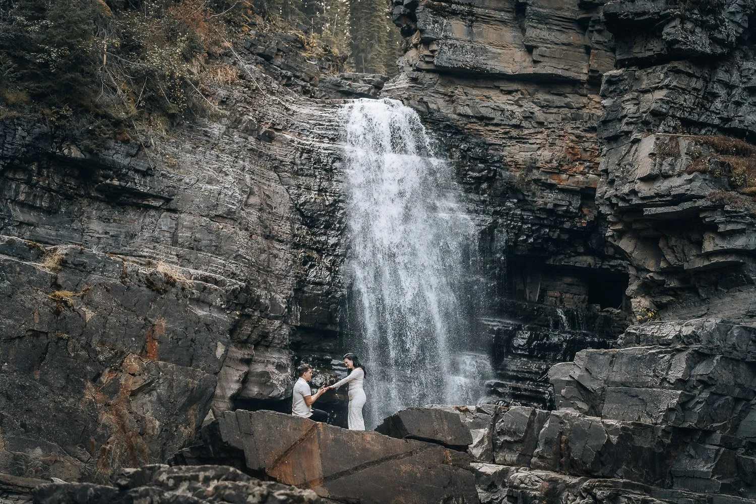 Engagement photos in front of the waterfall