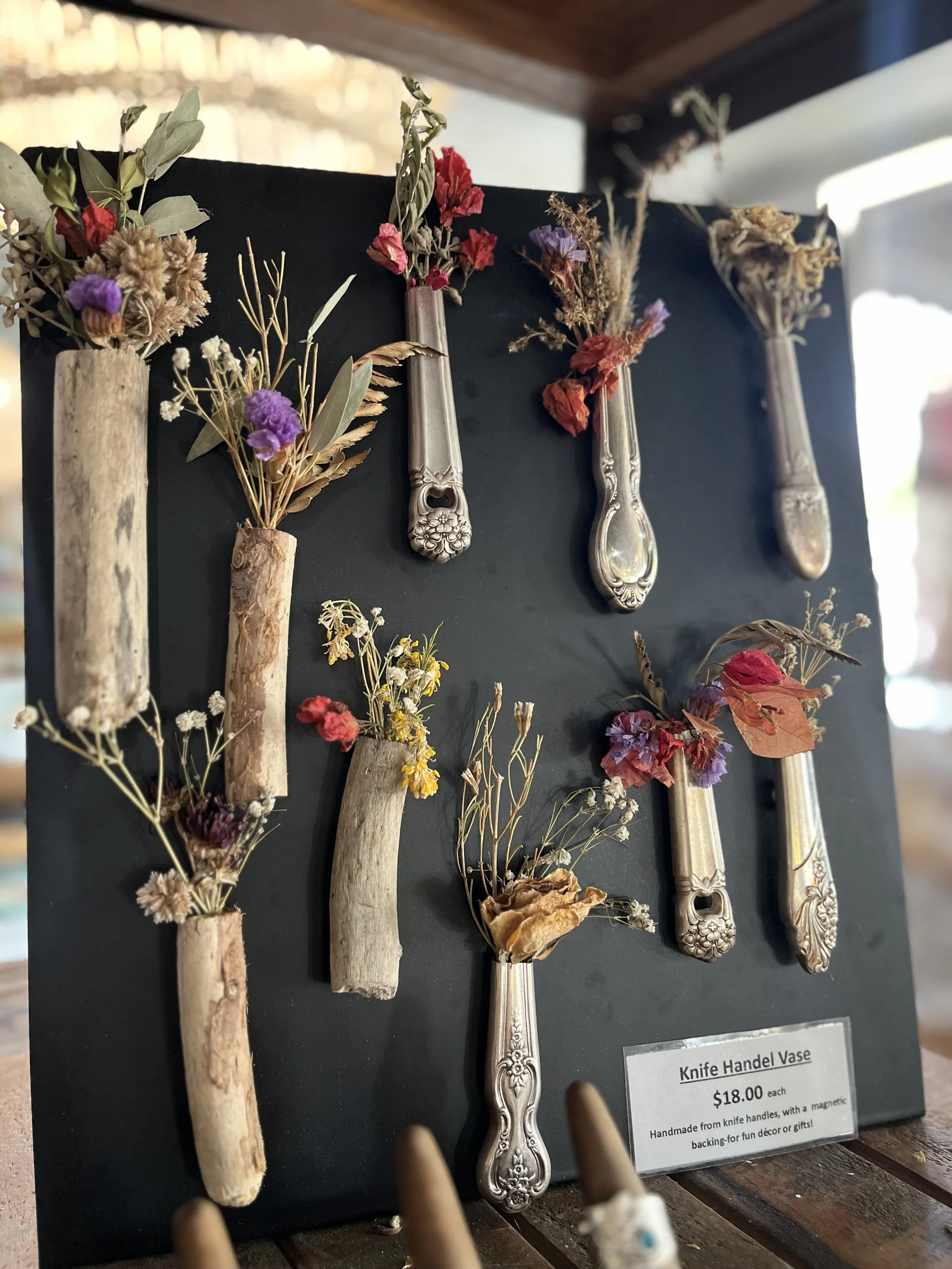 Handmade knife handle vases with dried flowers, displayed on a black board with magnetic backing for unique home décor or gifts. Available at Rustic and Modern Collective in Upland, CA.