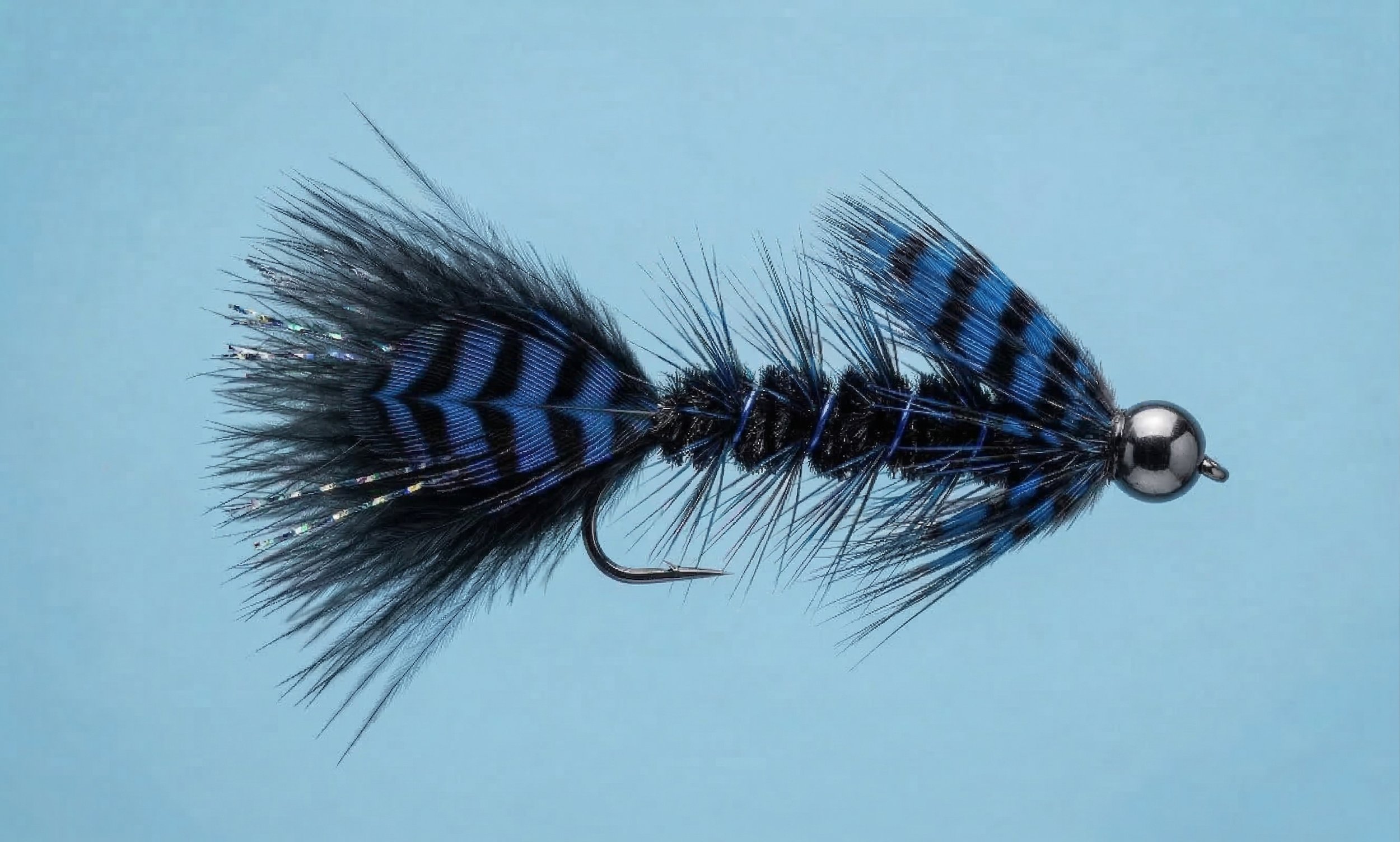 Obsidian Attractor steelhead fly pattern prototype with black and blue streamer profile designed for low-light, deep-water conditions.