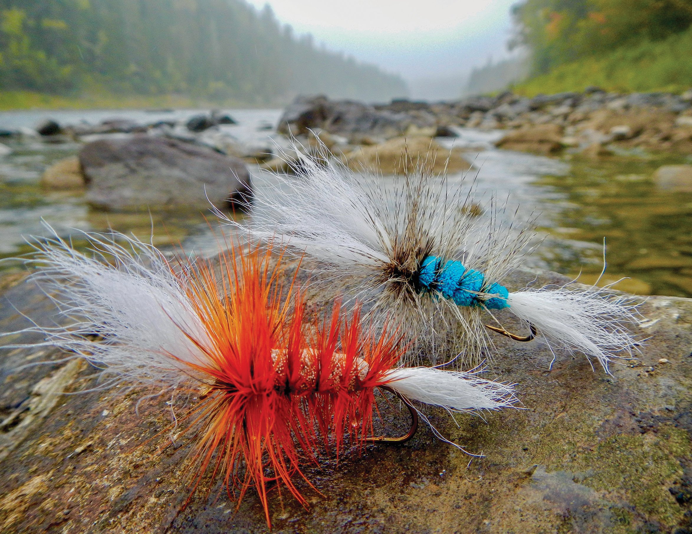 A pair of Québécoise-style Bombers sit at the edge of a promising pool on the Bonaventure River
