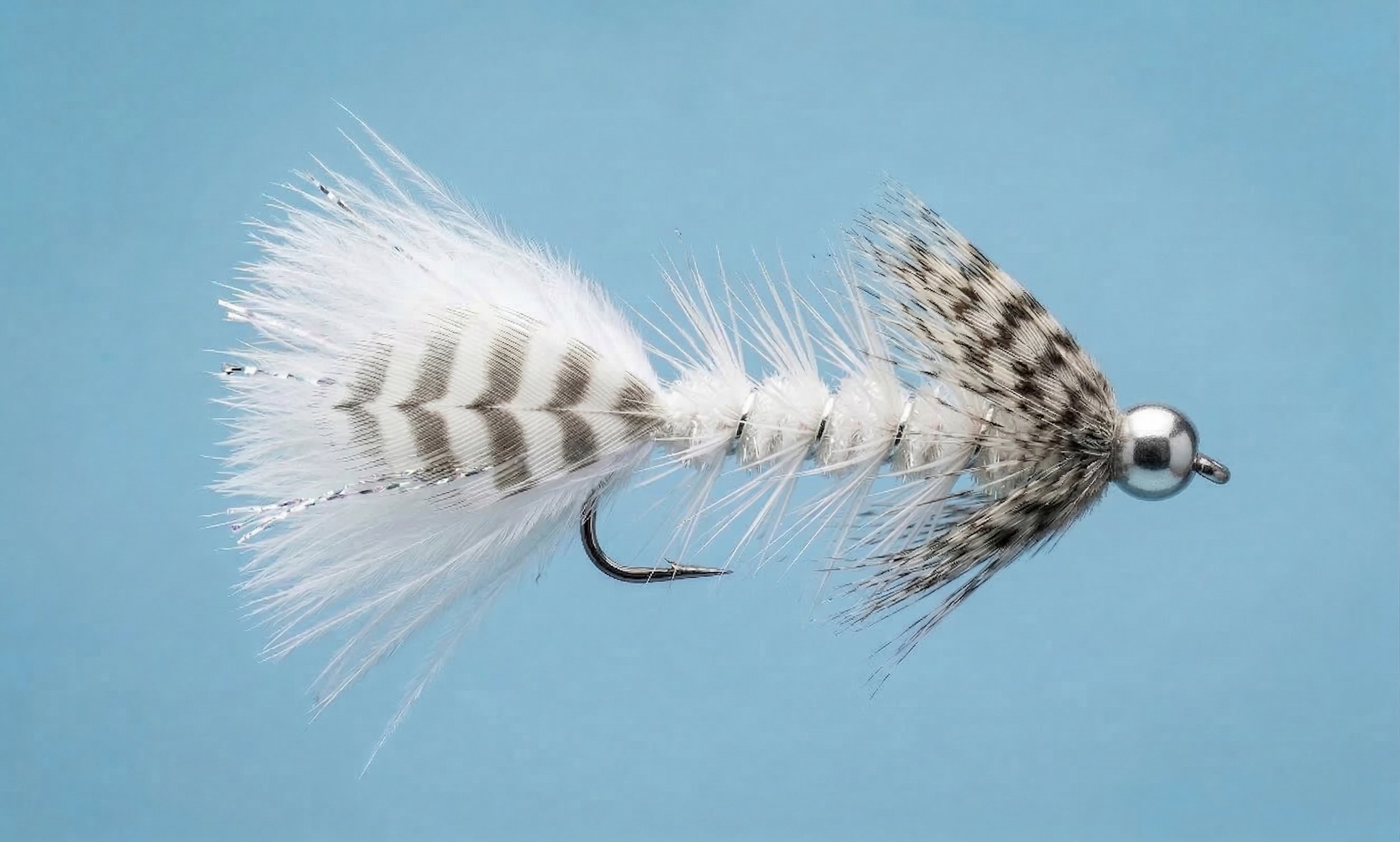 White Winter Ghost steelhead fly pattern with translucent white profile designed for clear, cold winter water conditions.