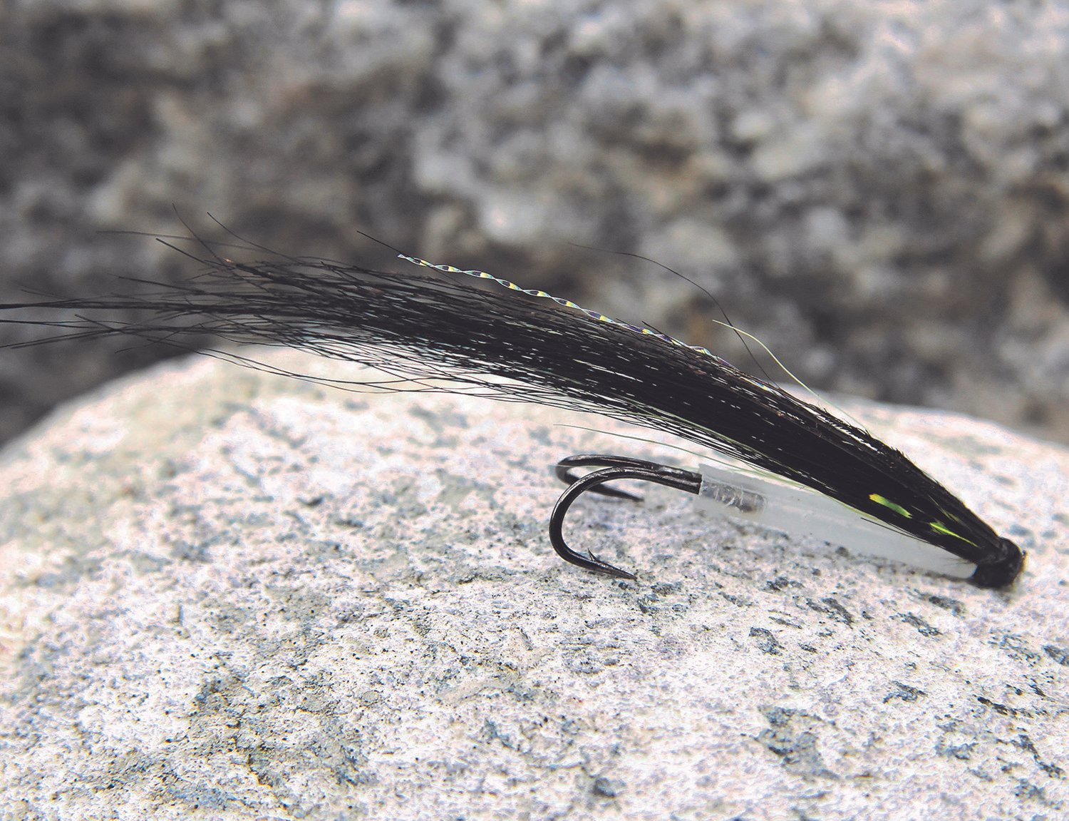 An image of A well-used Sunray variation tied by Øystein Aas. Note the marks from numerous sharp salmon teeth on the tube.