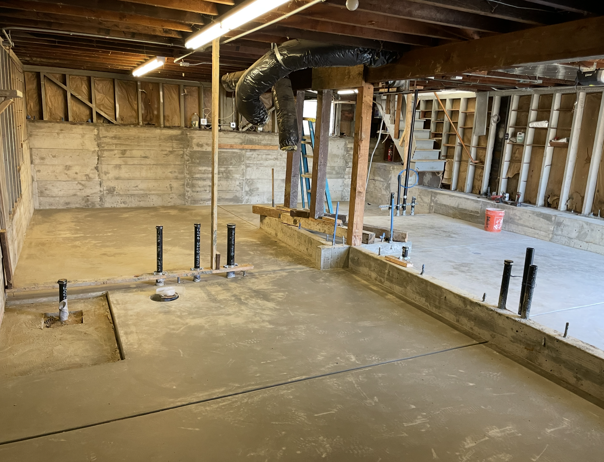 Unfinished basement with drywall, exposed framing, plumbing, and ducts.