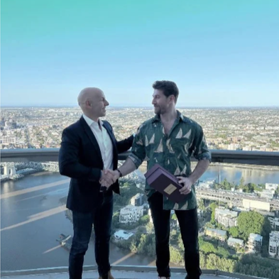 Prestige Real Estate agent shaking hands with a high-net-worth purchaser, symbolising trust, professionalism, and premium property transactions.