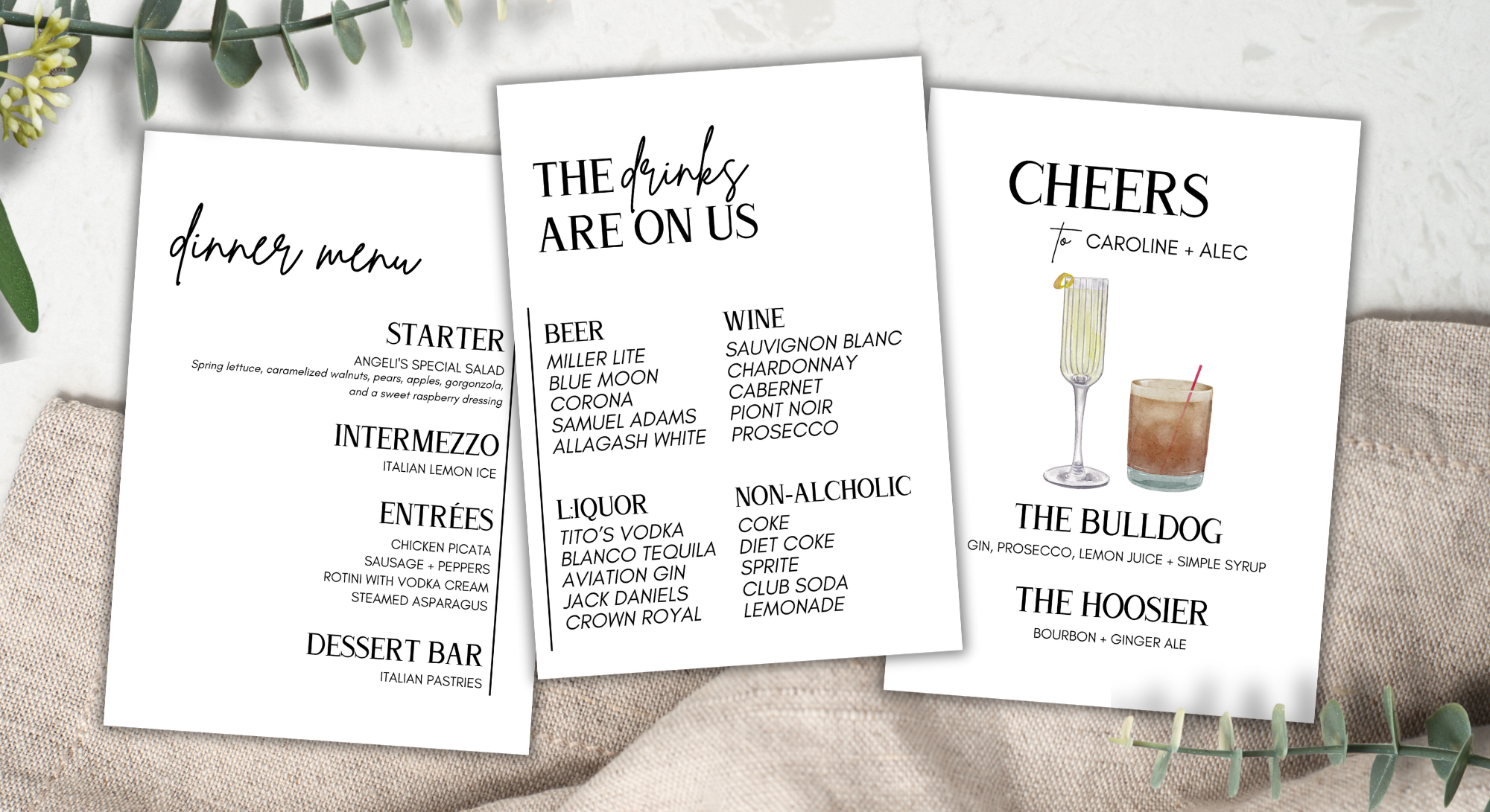 Three white dinner menus with black text, one listing food and drink options, one listing drink options, and one with cocktail names, surrounded by green leaves and placed on beige fabric.