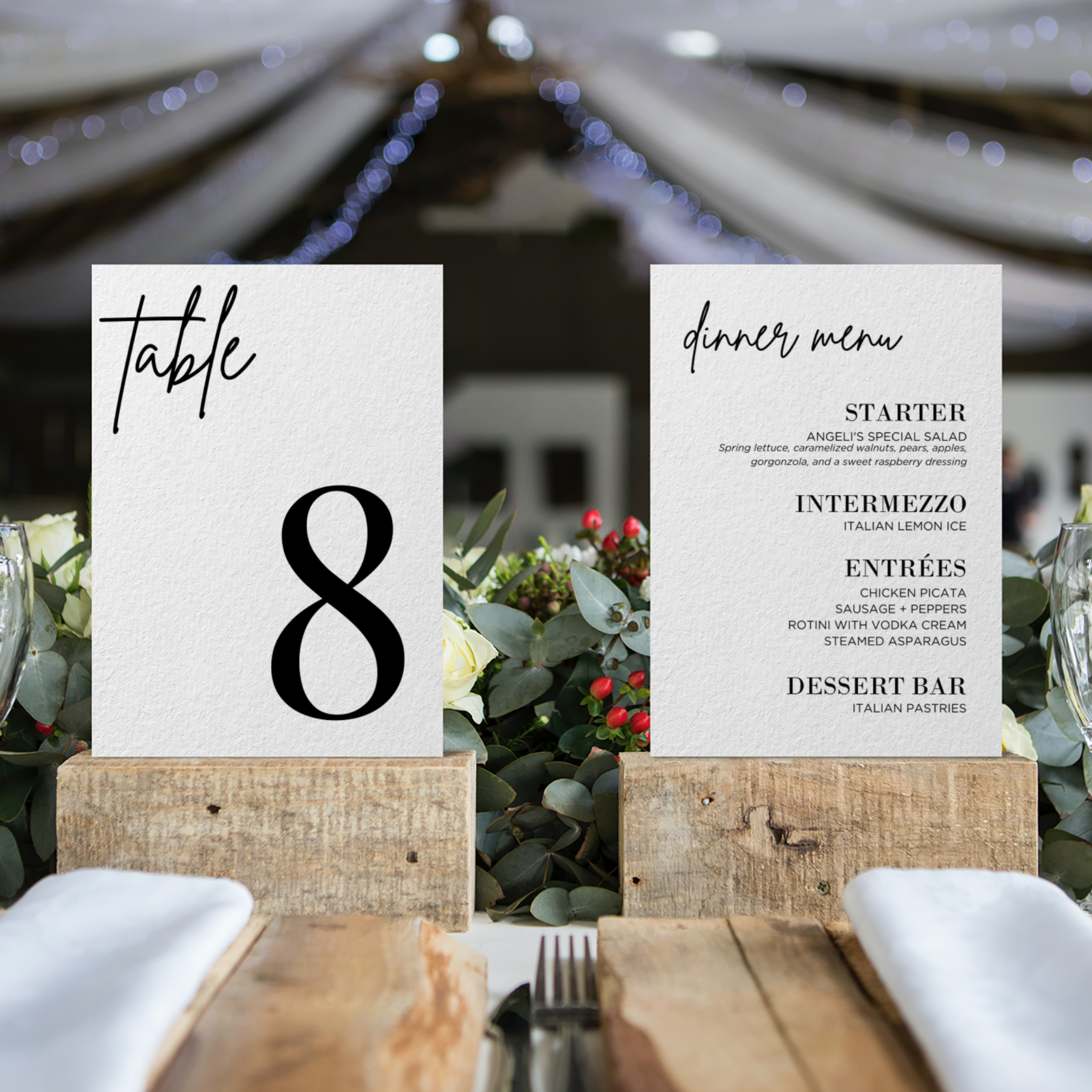 Table 8 wedding reception table numbers and menu with floral and greenery decorations.