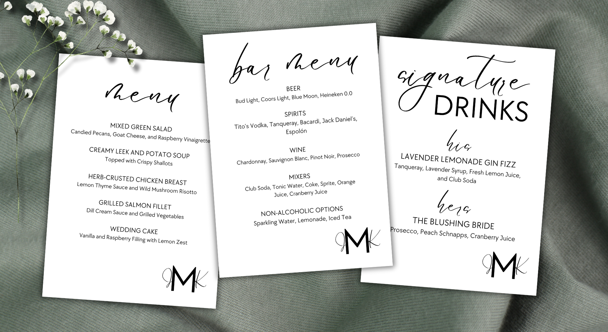 Three wedding menu cards with black script and serif fonts, decorated with a small logo at the bottom, placed on a grey fabric with a small white flower to the upper left.