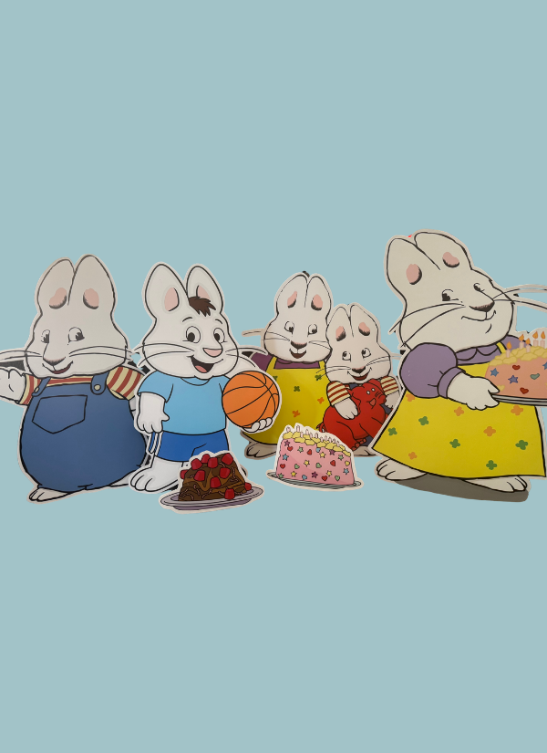 Five cartoon rabbits standing in a row with cakes and a birthday present against a solid light blue background.