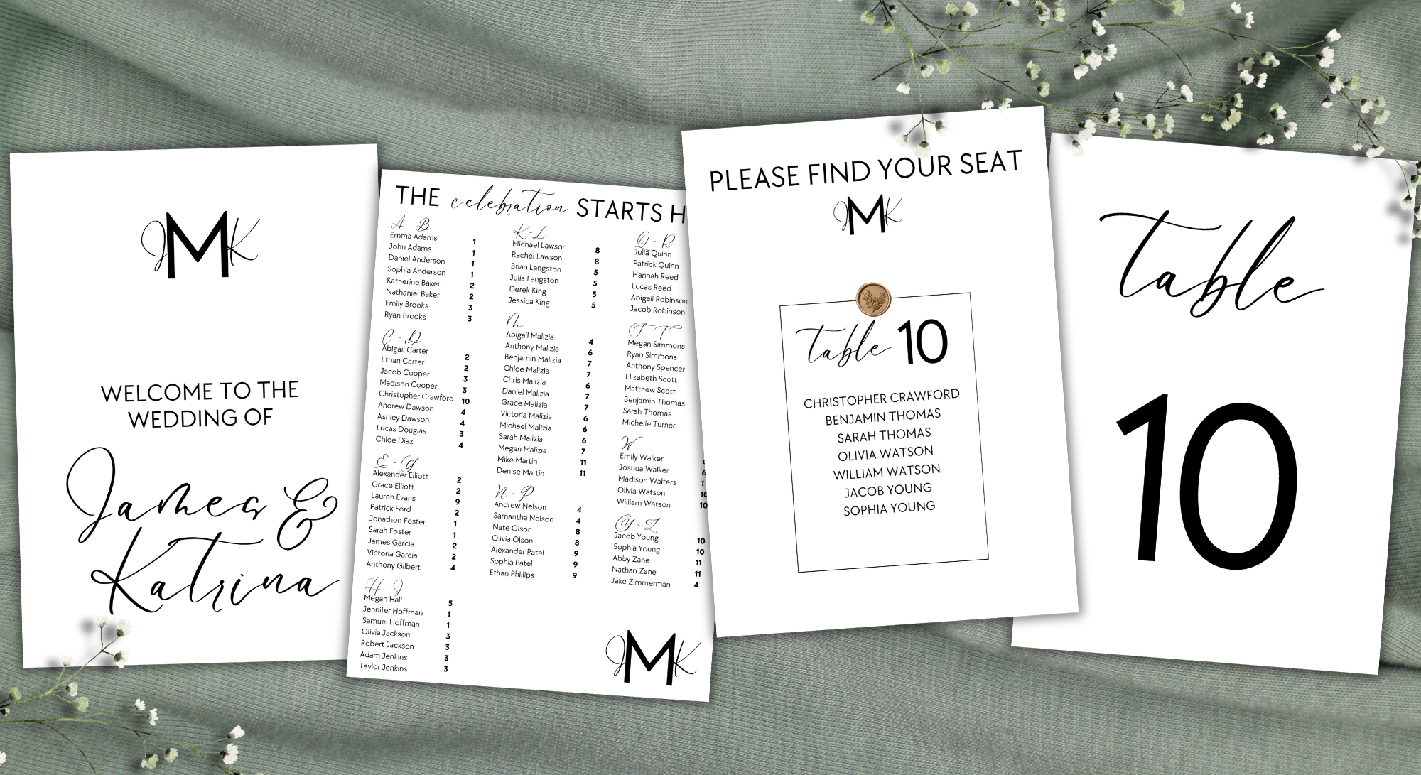 Wedding seating cards on a light green fabric background with small white flowers.