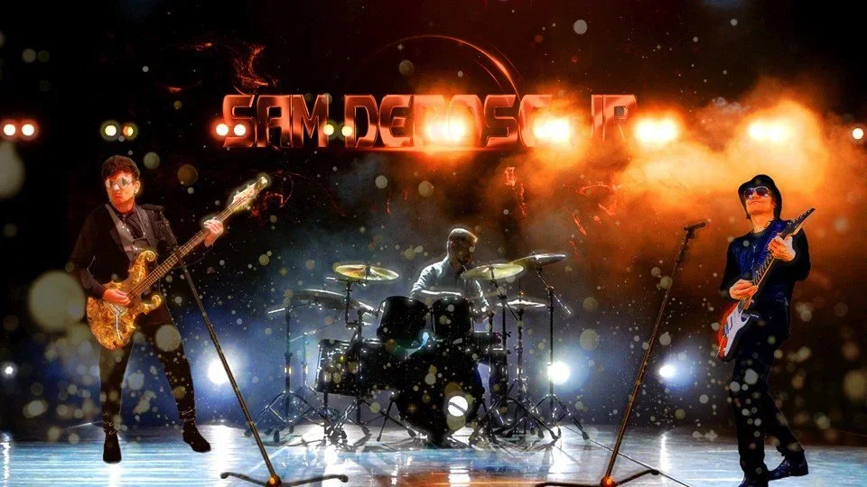 Sam DeRose Jr performing on stage with three musicians, two playing guitars and one on drums, under colorful stage lights and effects.