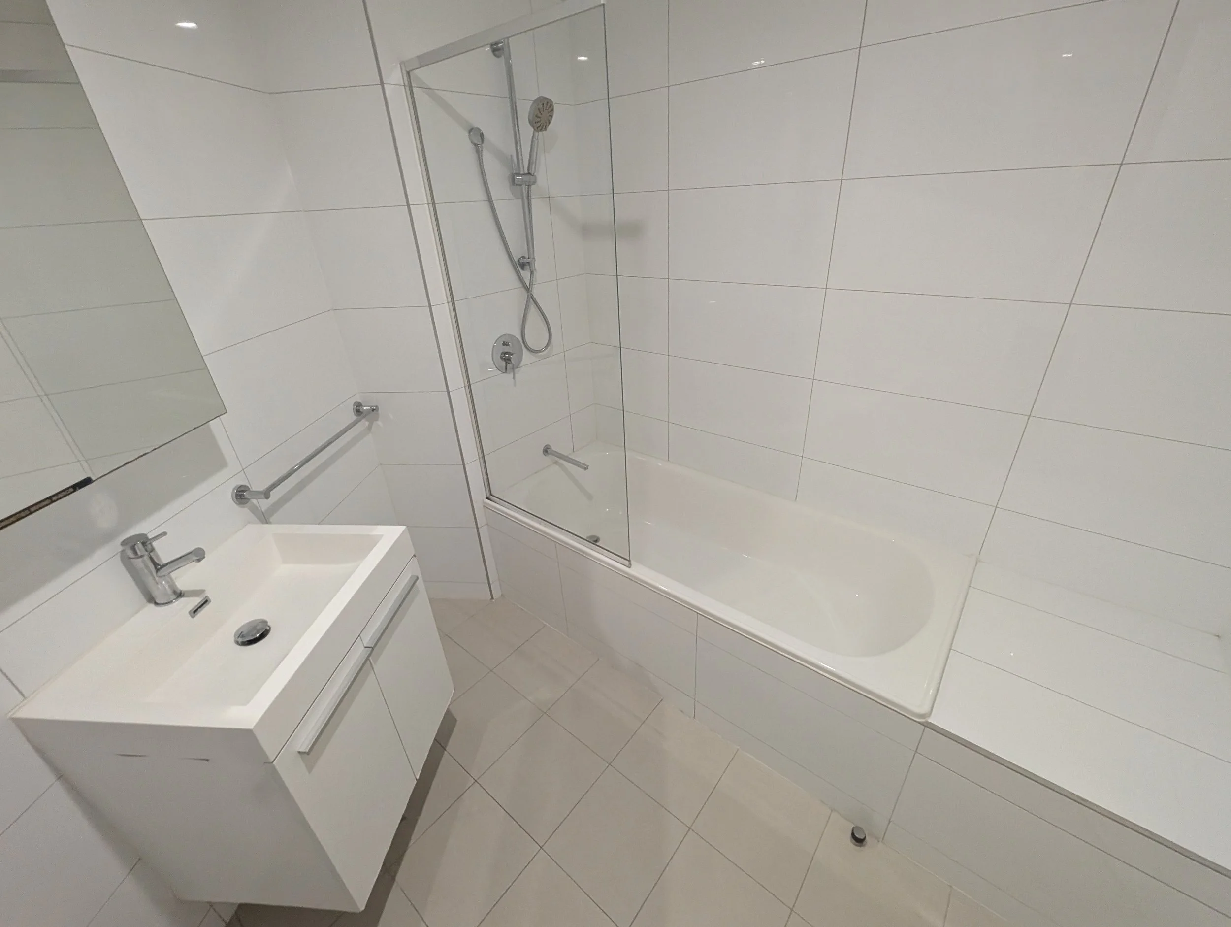 White clear bathroom clear mirror and shower screen sink