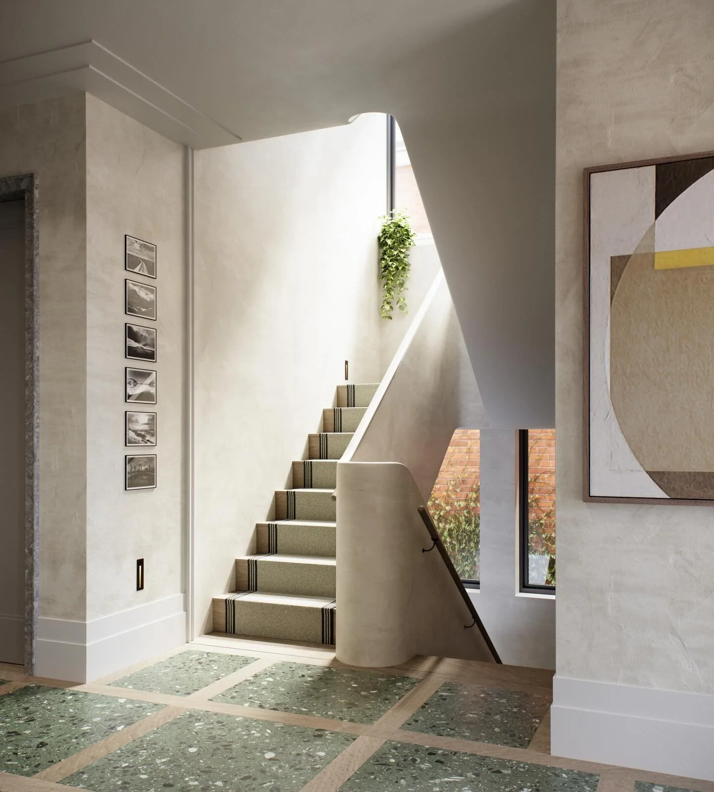The central staircase and entrance hall of each of the Wimbledon Walled Villas&rsquo; is finished in Tadelakt, a material which is tactile, burnished, and quietly reflective, helping to carry natural light from the large windows on each landing deep 