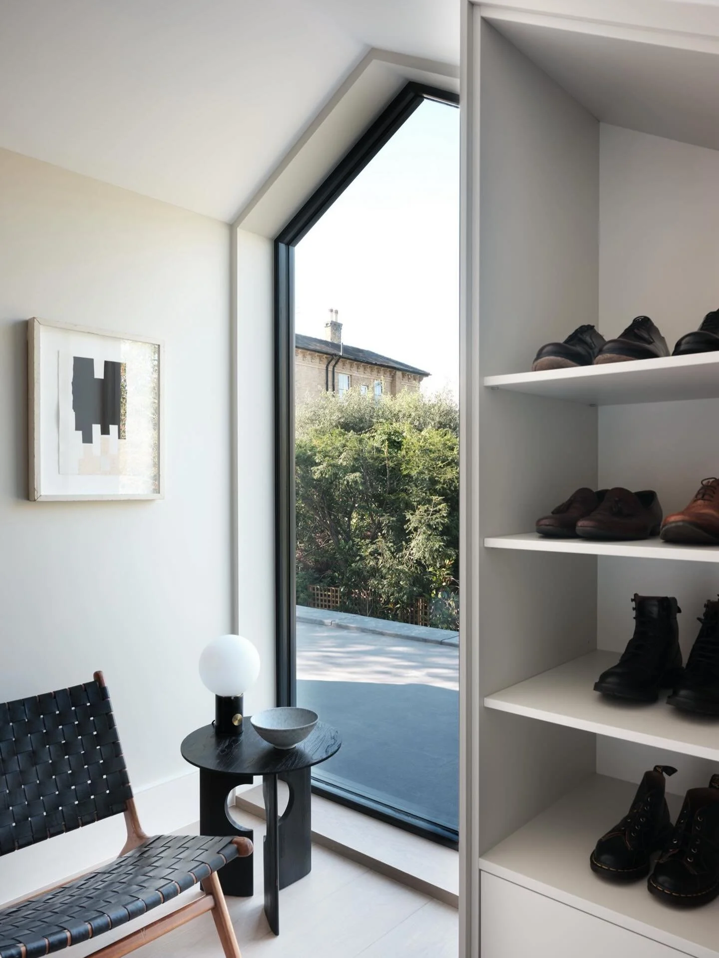 The dressing room at our High Cedar Drive project was designed for more than just dressing. A contemporary floor-to-ceiling gable-shaped window draws natural light deep into the room, creating a space for relaxation, contemplation, and the quiet mome