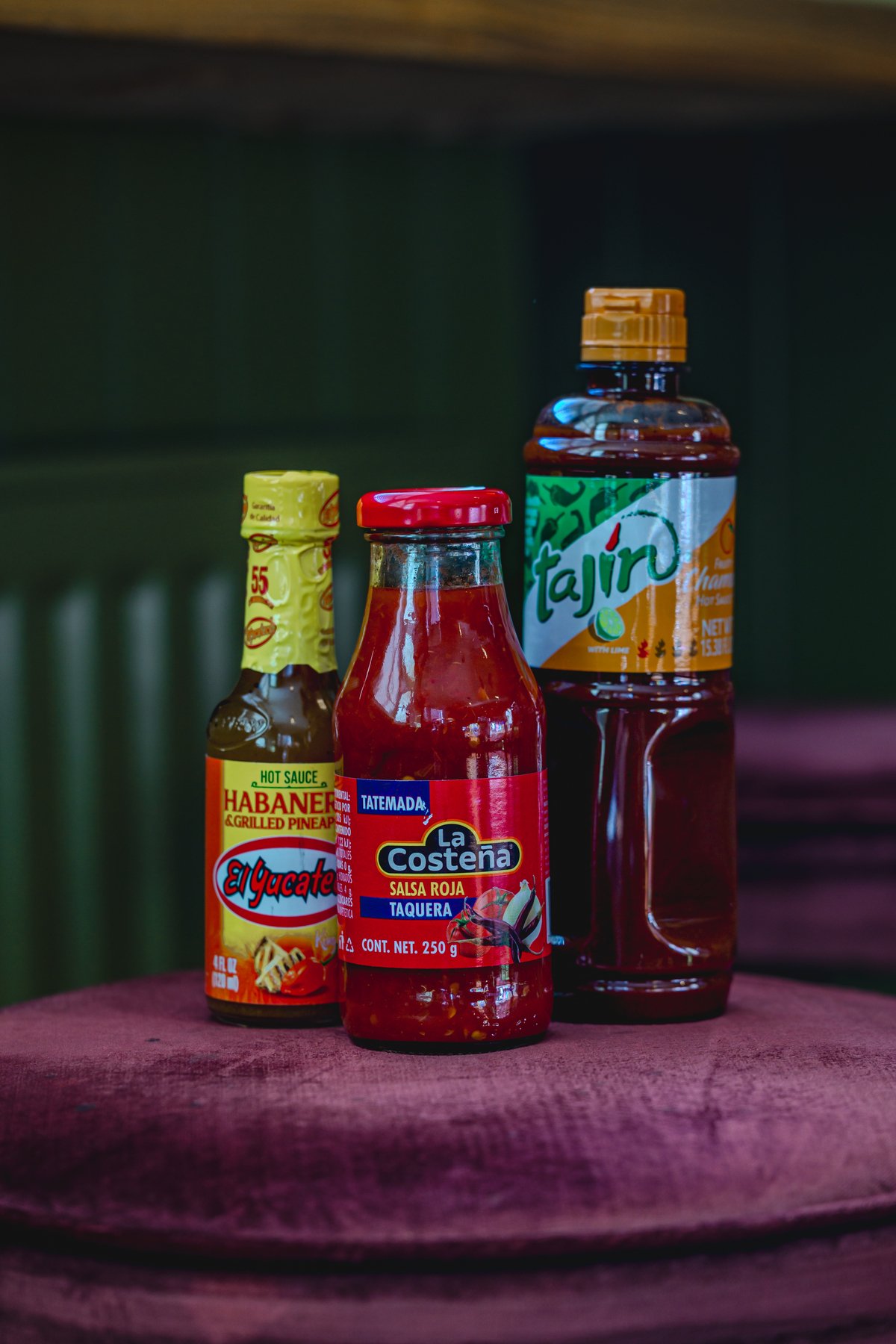Bottles of hot sauce and salsa on a table