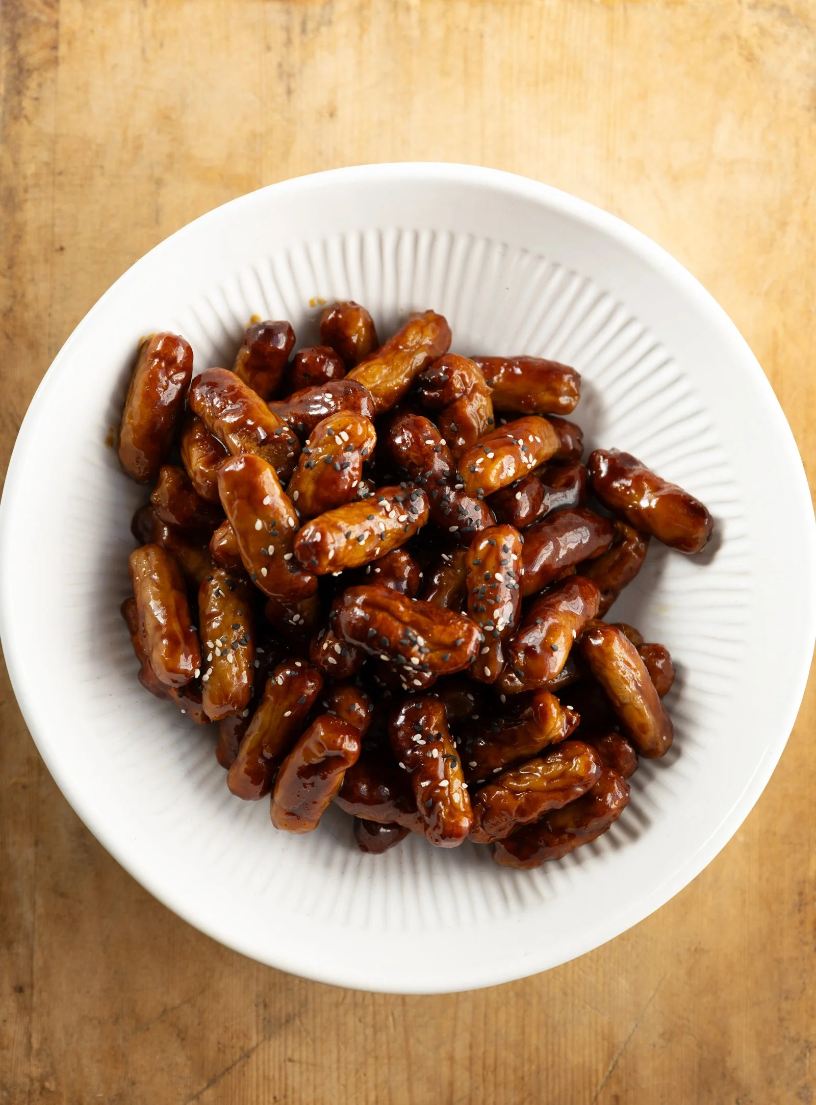 Glazed Cocktail Sausages: Little sausages glazed with soy, hoisin and honey, finished with sesame.