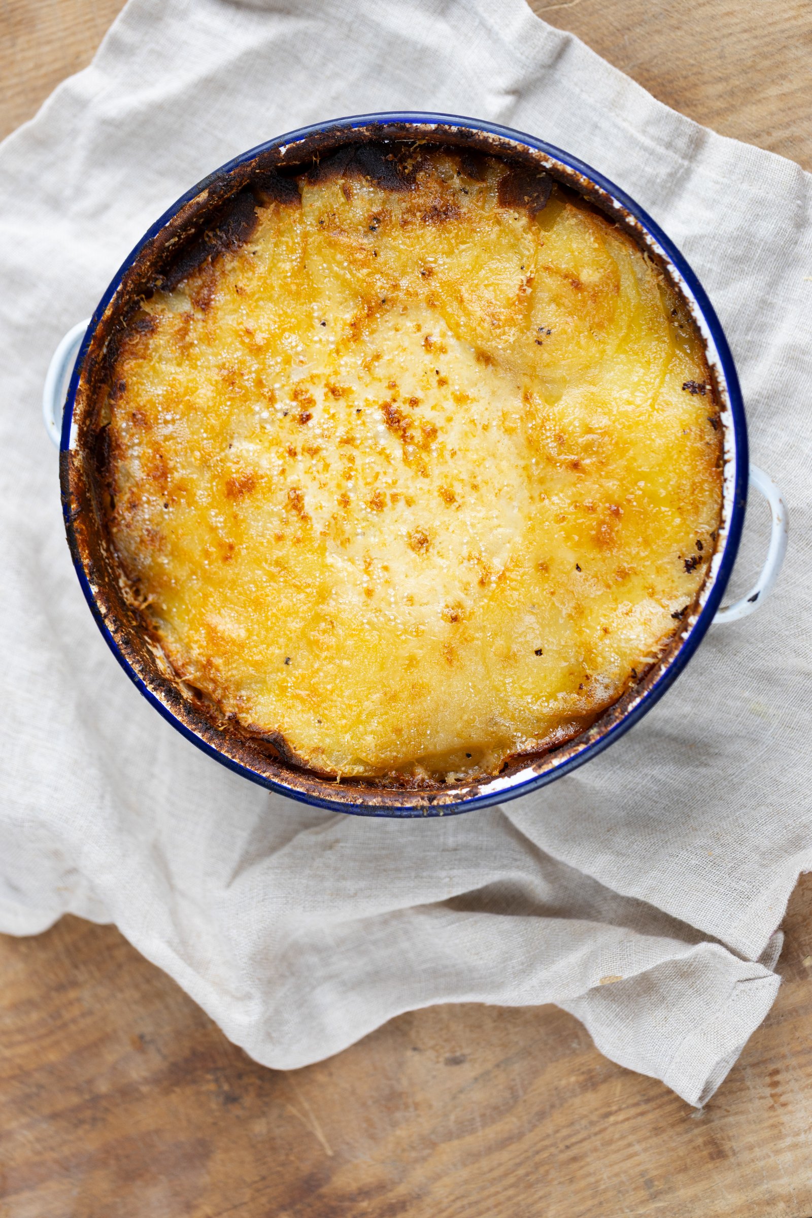 Potato Gratin: Fine layers of potato baked with cream until tender and golden.