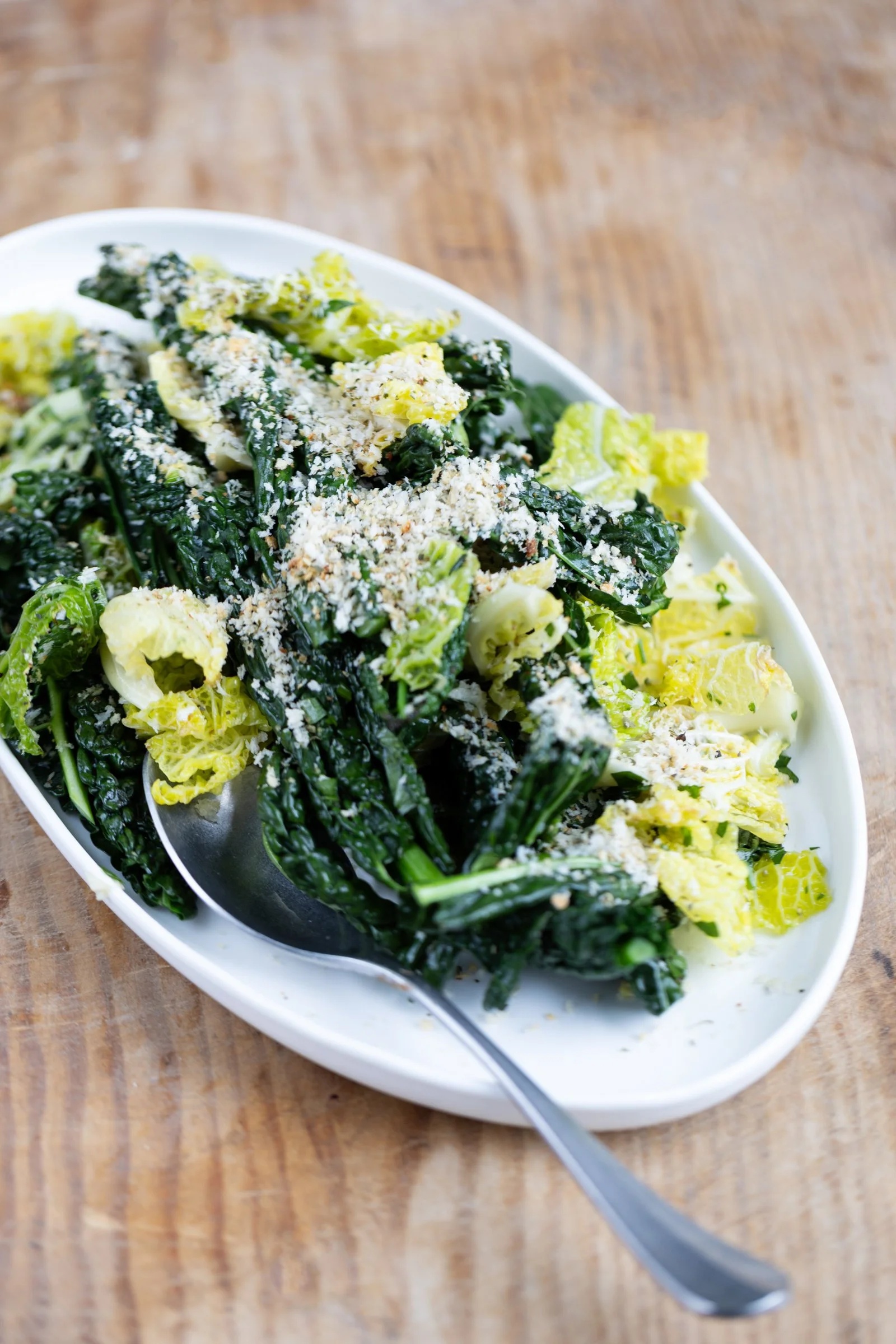 Wilted Greens with Garlic and Anchovy Crumb: Tender wilted greens topped with a savoury garlic and anchovy crumb.