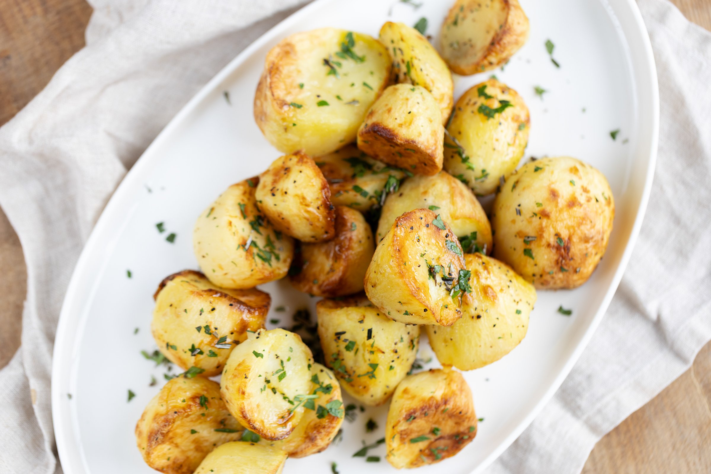 
Roast Potatoes: Golden roast potatoes with crisp edges and fluffy centres.