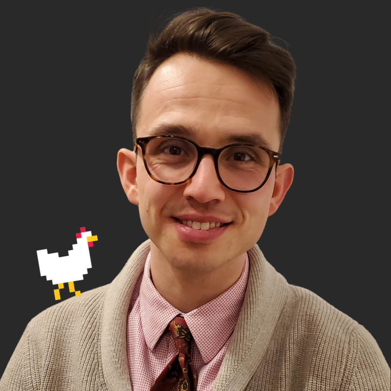 A young man with brown hair, glasses, and a beige cardigan, smiling at the camera, with a pixelated chicken graphic edited into the photo against a dark background.