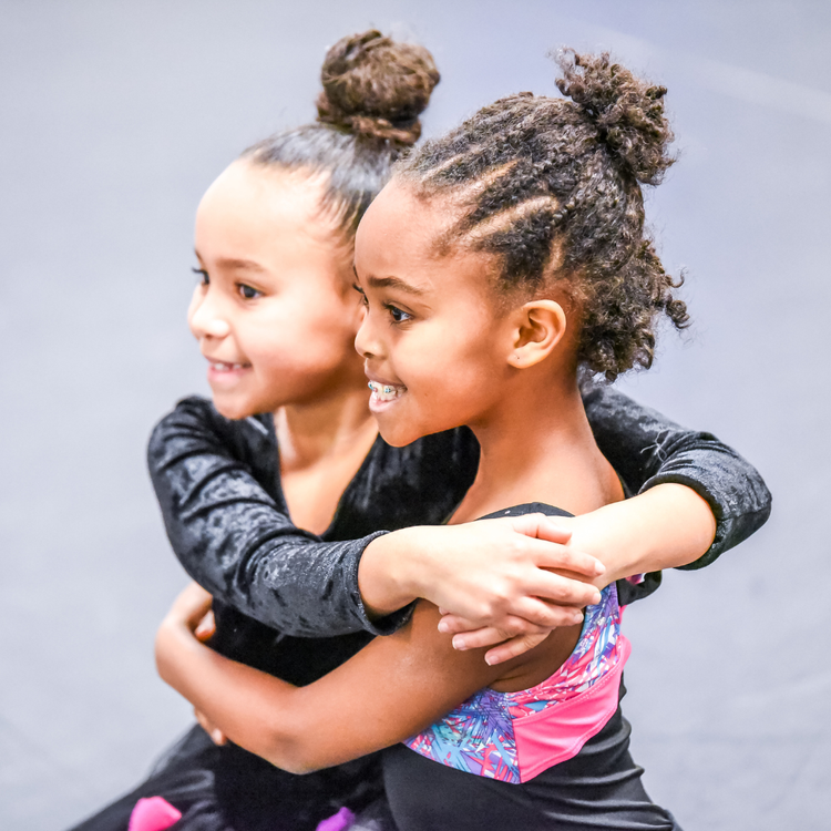 Two young AIM dancers smiling