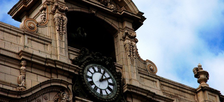 Image of clock on large theater building