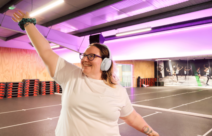Rhiannon Cooper wearing noise-cancelling headphones in the gym