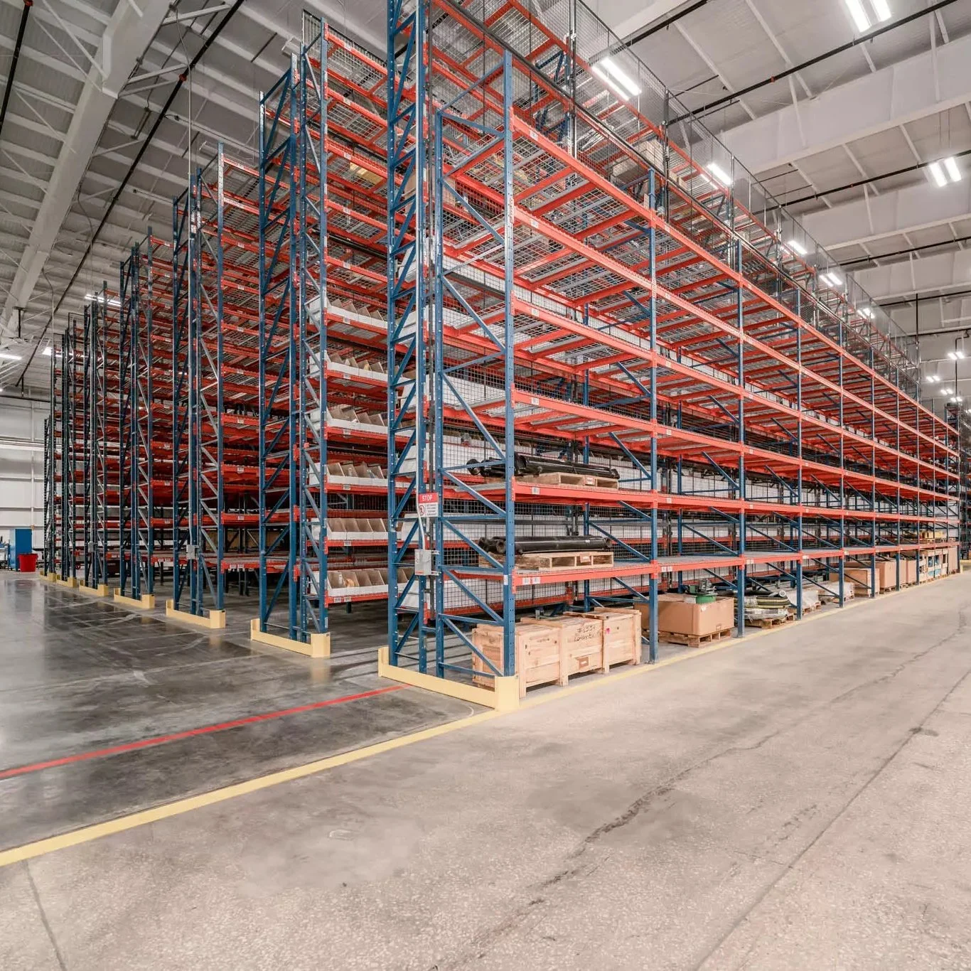 Empty warehouse storage racks with pallets and boxes.
