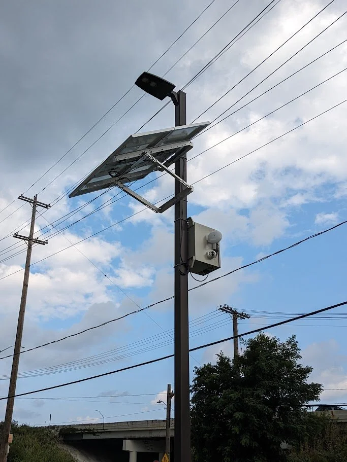Solar-powered cameras in the middle of the school parking lot with point-to-point WIFI connection.