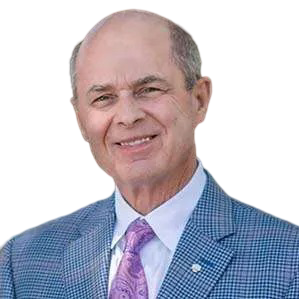 Portrait of a man in a blue checked suit, white shirt, and purple tie smiling against a white background.