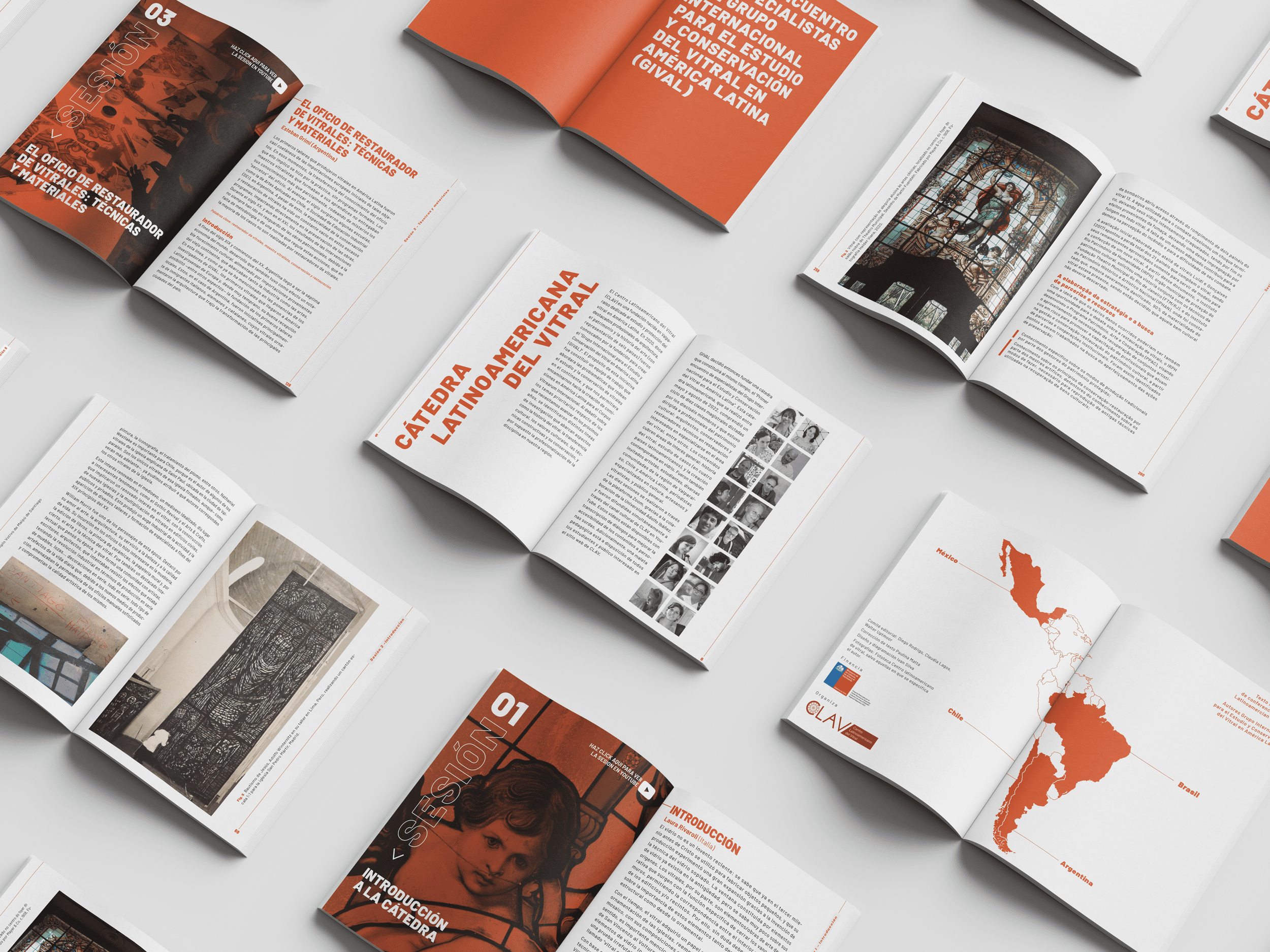 Open magazines and brochures with Latin American artwork, maps, and text in Spanish displayed on a white surface.