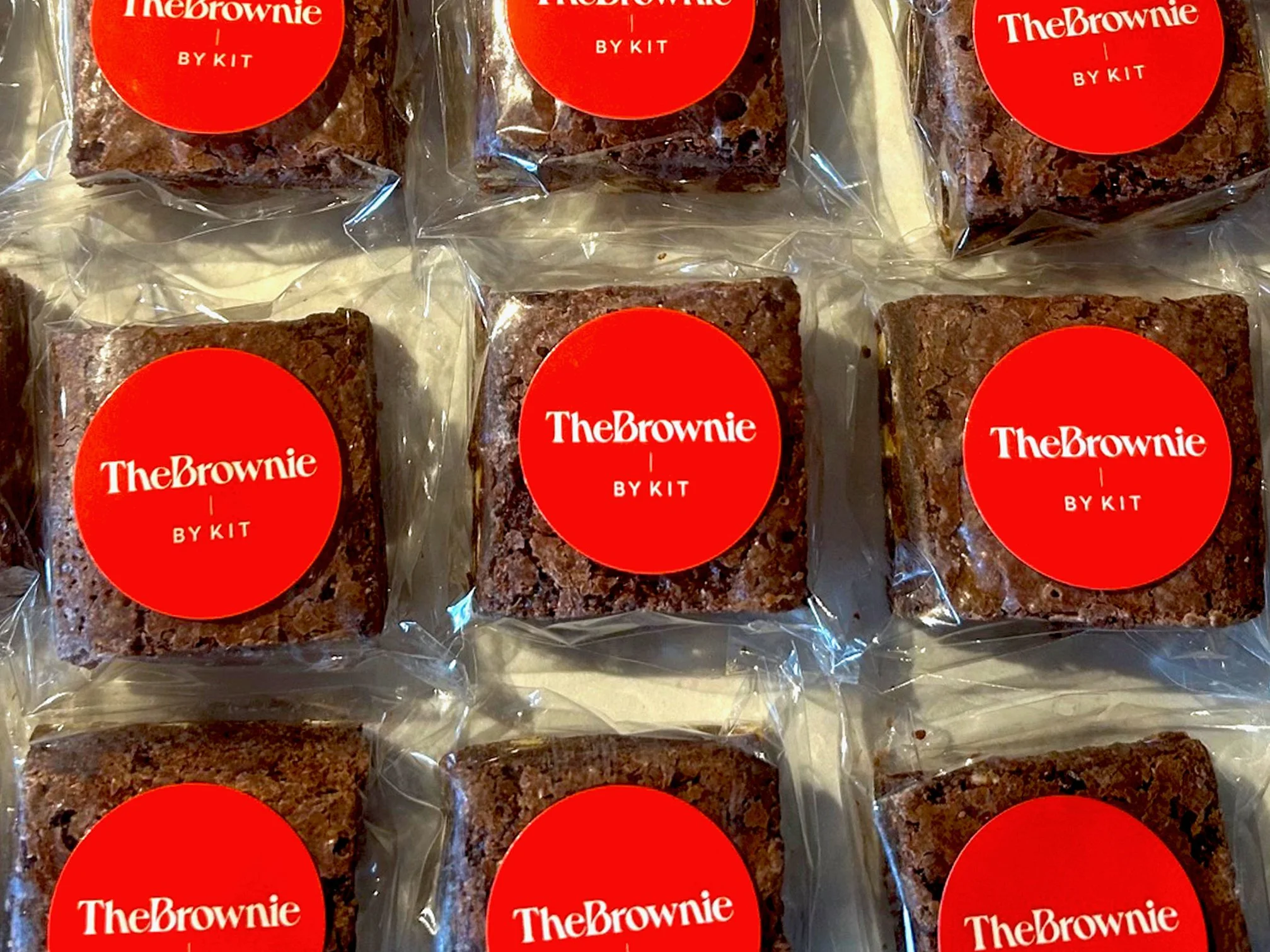 Individually wrapped brownies with red "The Brownie by Kit" labels.