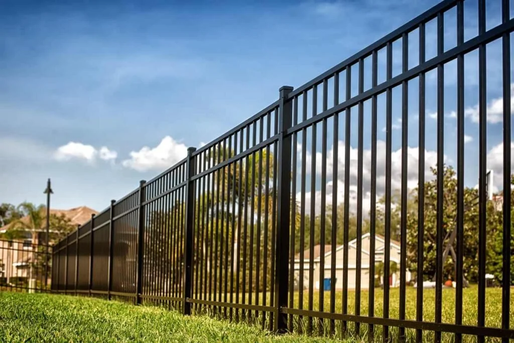 Black aluminum ornamental fence installed along a residential property line