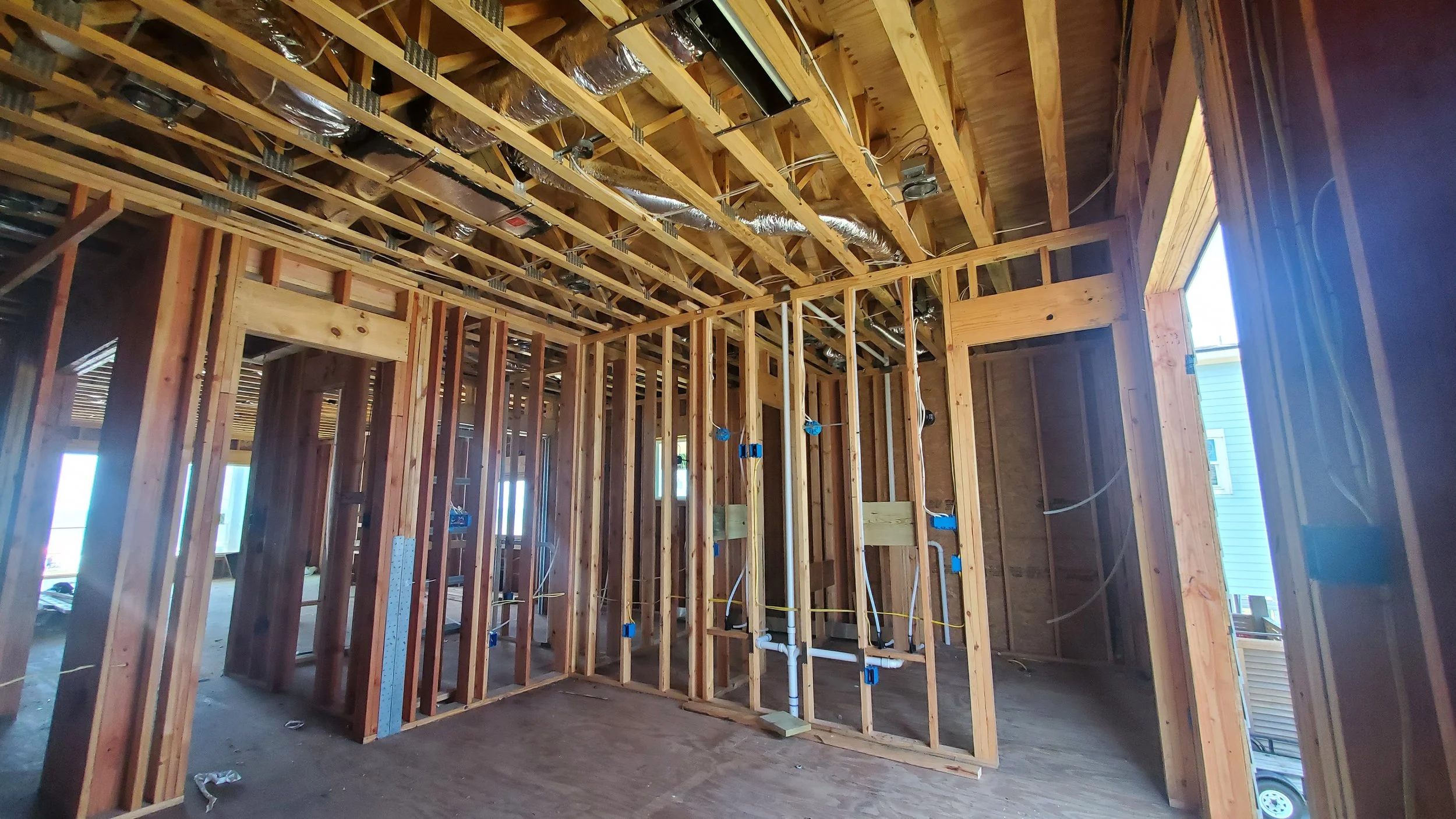Framed interior with low-voltage wiring and device boxes in place before drywall