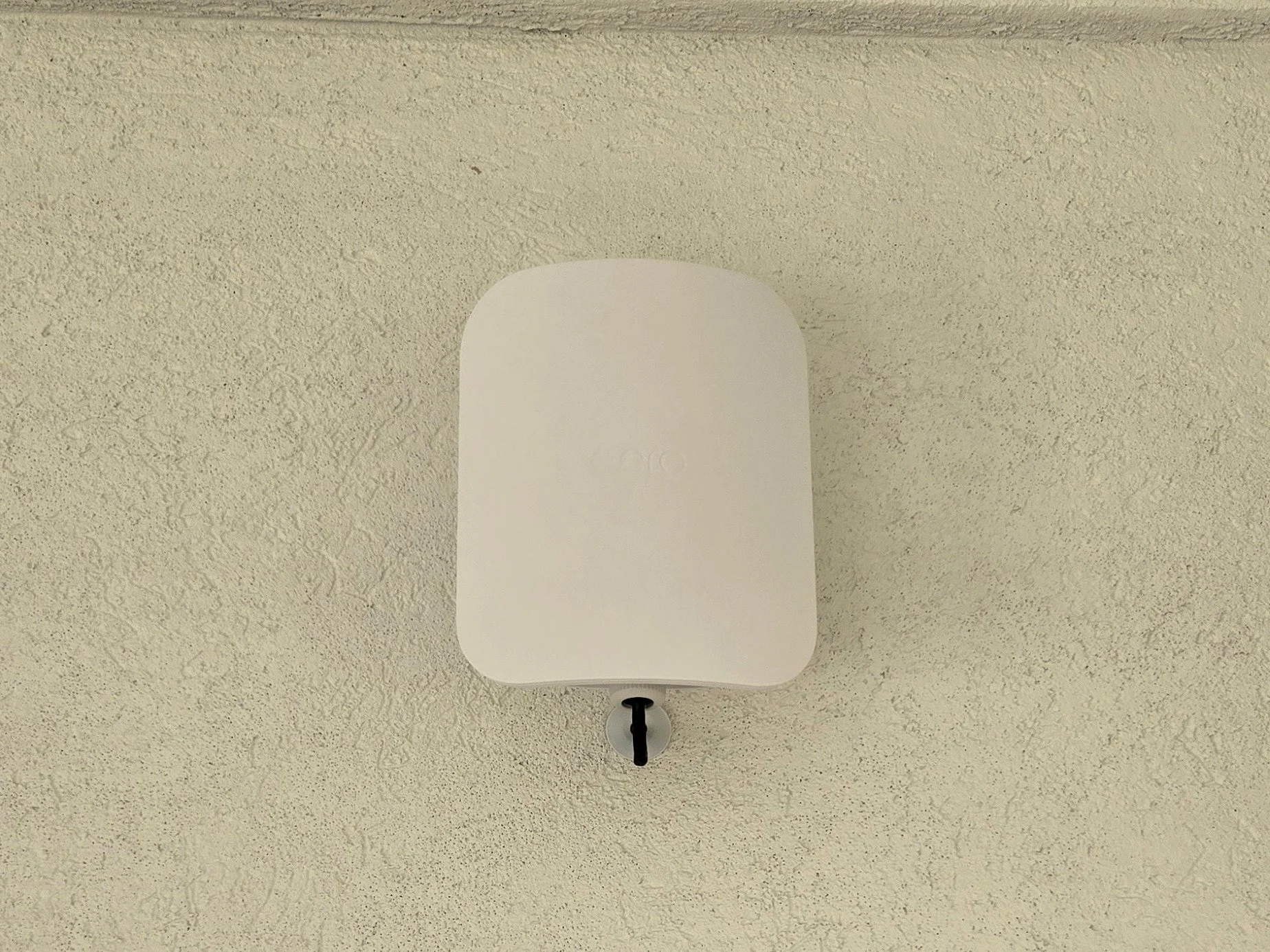 Outdoor eero Wi-Fi access point installed on a Houston home exterior by Dynamiq.