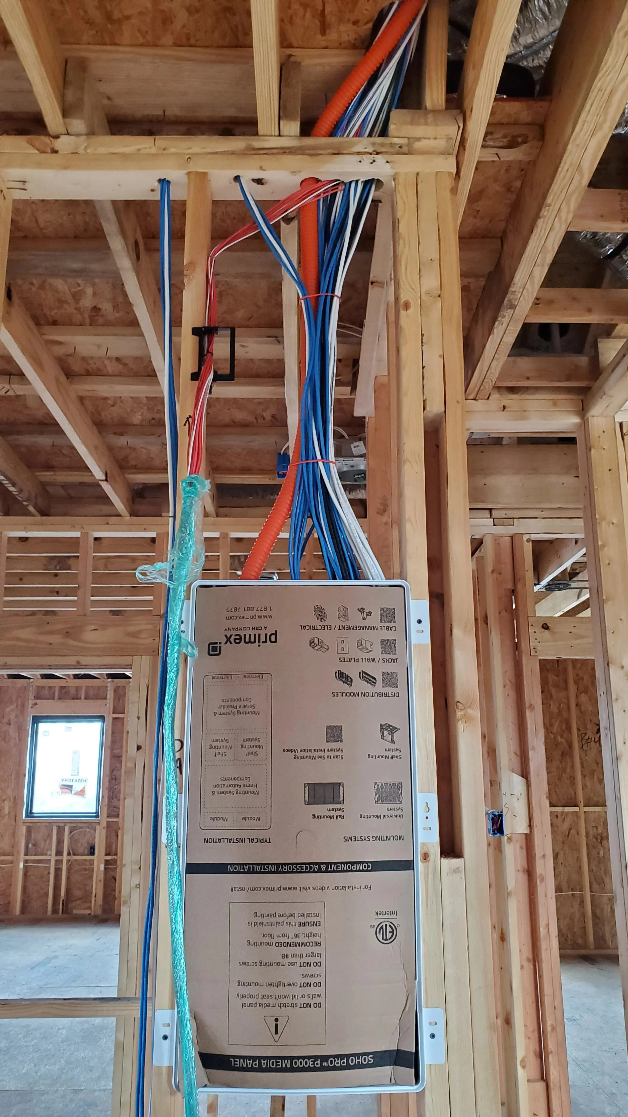 Low-voltage prewire installed in framing before the walls close in a Houston custom home