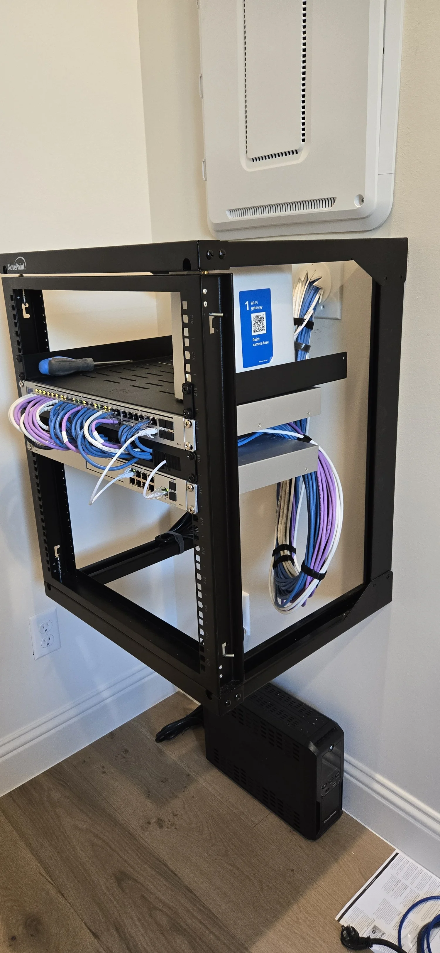 Home network rack with switches and cabling in a Bellaire, TX residence