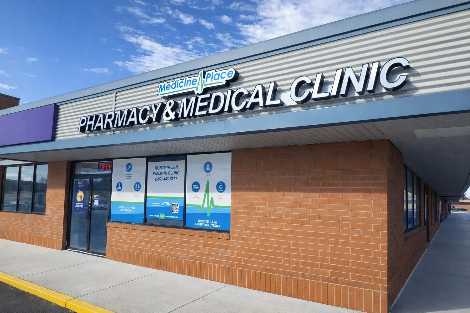 Exterior view of Medicine Place pharmacy and medical clinic storefront with signage and windows, brick exterior, and blue sky.