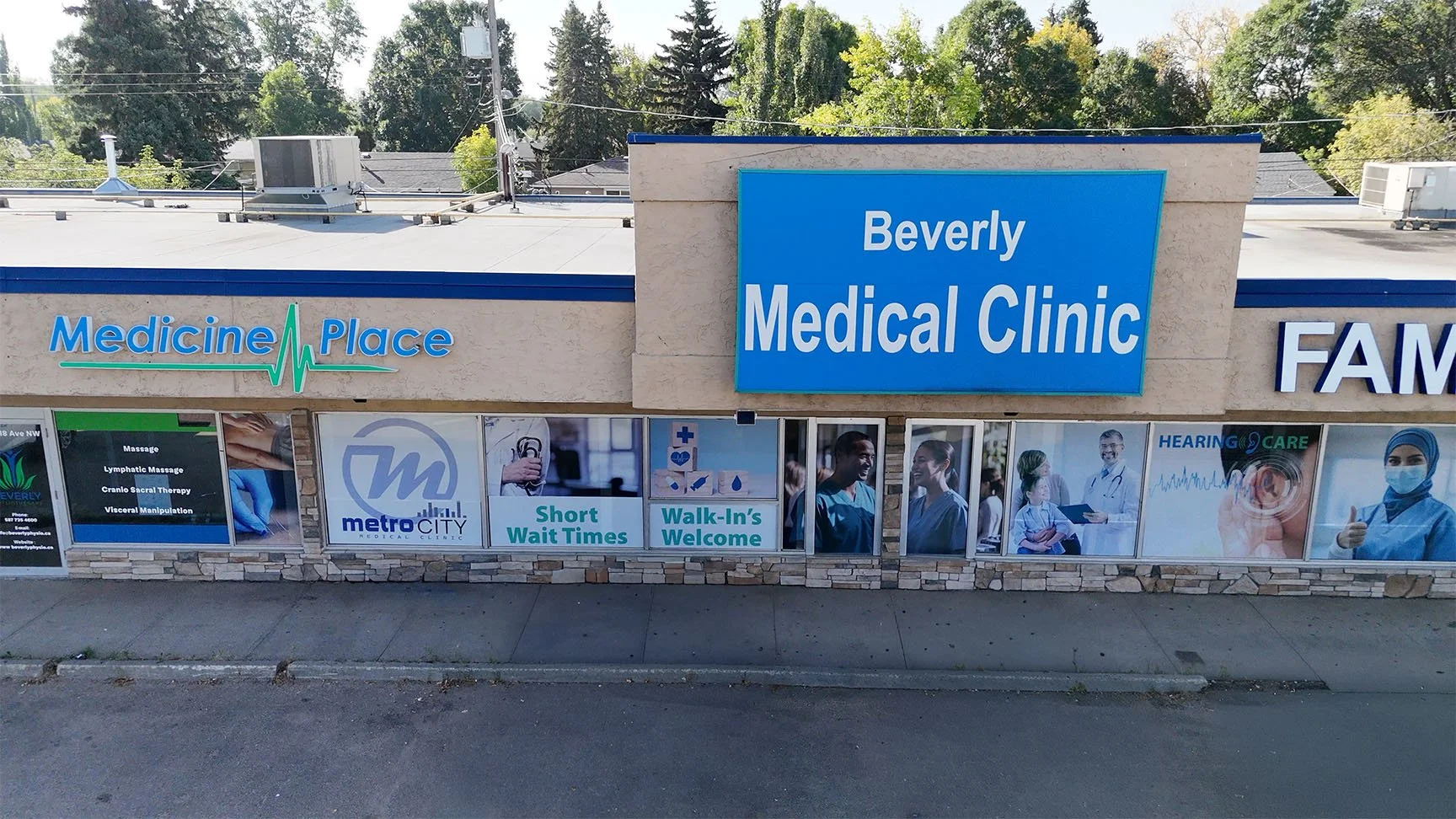 Exterior of Beverly Medical Clinic with signs for Medicine Place and Metro City Medical Clinic, including advertisements for short wait times, walk-ins welcome, and various medical services like hearing care and vaccinations.