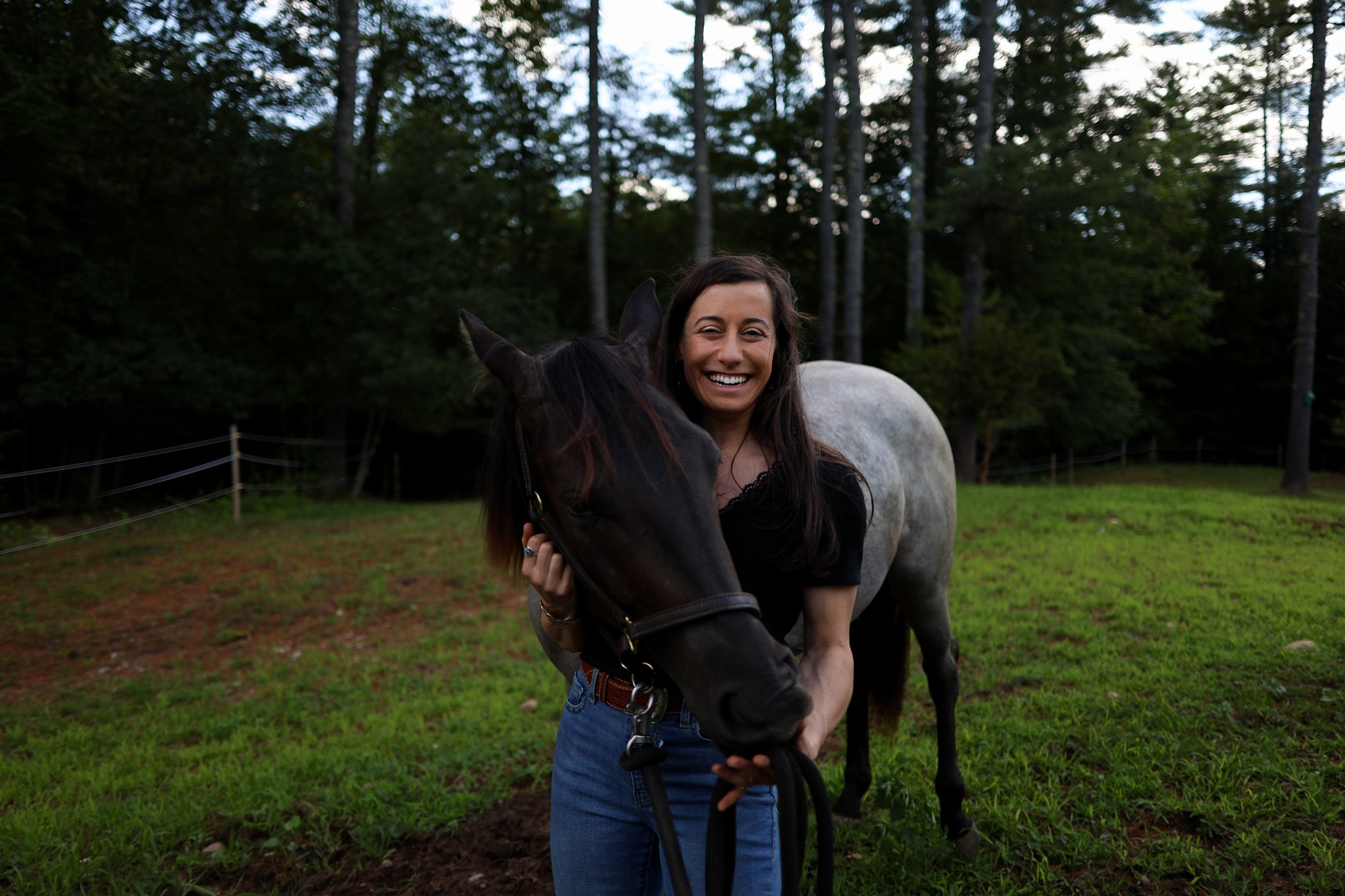 women smiling with horse