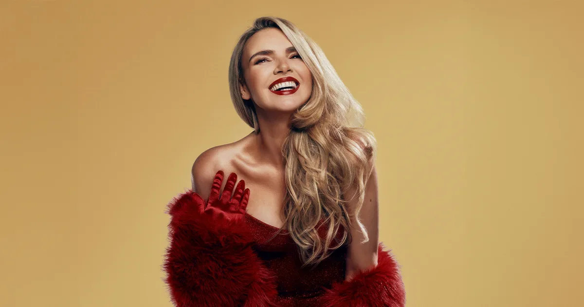 beautiful blonde woman in red dress and fur with gloves, with red lipstick on a gold background